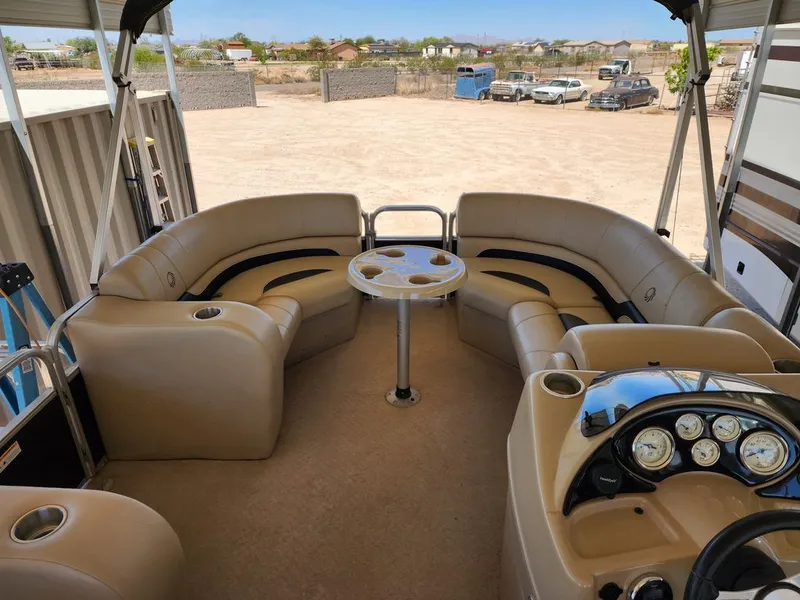 Slide: The Image of Interior of a 2015 Lowe SS210 pontoon boat with beige seating. - 9