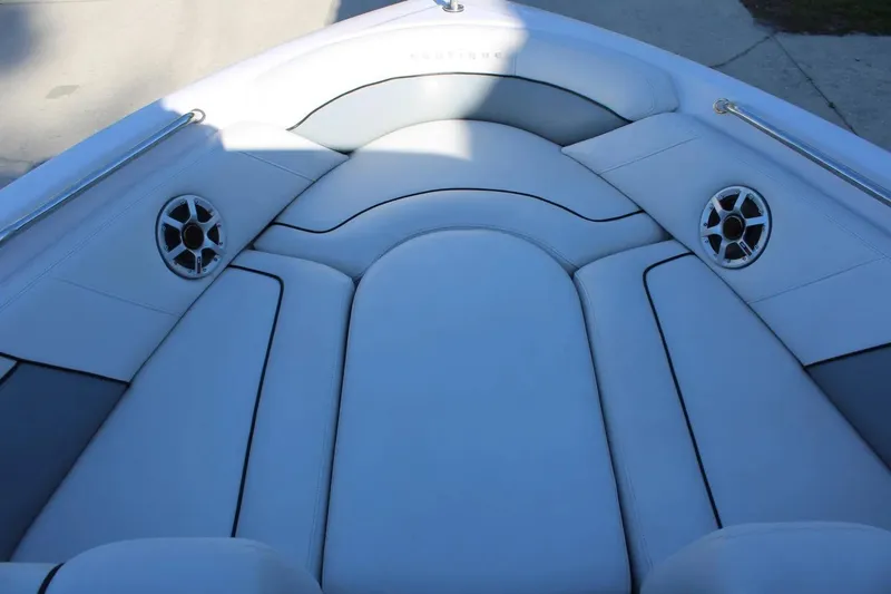 Slide: The Image of 2007 Nautique Super Air Nautique 230 boat interior with white cushioned seating and speakers. - 15