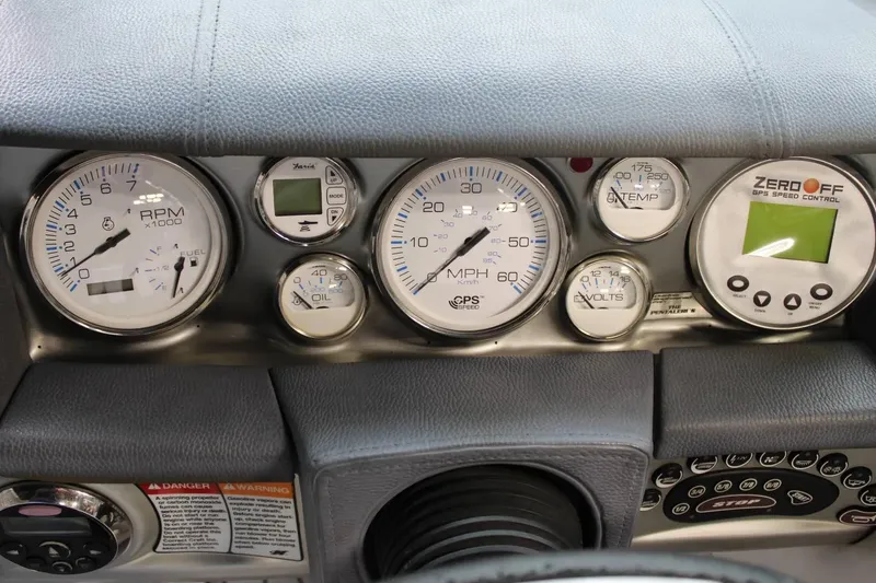 Slide: The Image of Dashboard of a 2007 Nautique Super Air Nautique 230 with gauges and controls. - 6