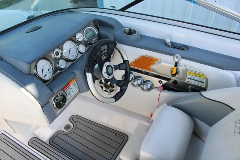 Slide: The Image of 2007 Nautique Super Air Nautique 230 dashboard with steering wheel and control panel. - 7