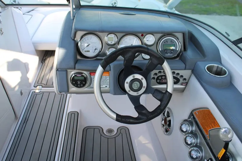 Slide: The Image of 2007 Nautique Super Air Nautique 230 dashboard with steering wheel and gauges. - 8