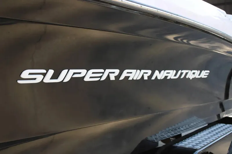 Slide: The Image of 2007 Nautique Super Air Nautique 230 boat side view with logo. - 9