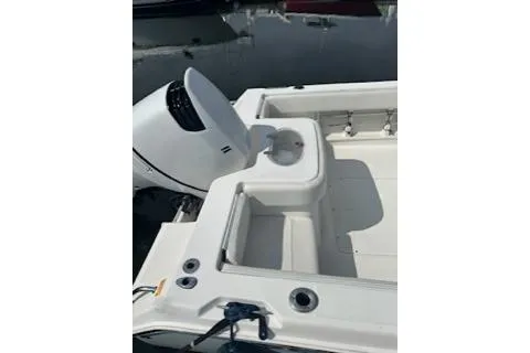 Slide: The Image of 2006 Sea Hunt Triton 220 boat with outboard motor and seating area. - 14