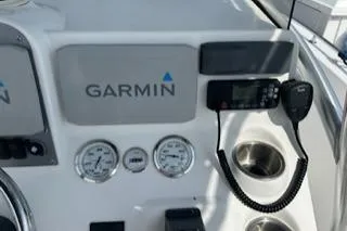 Slide: The Image of 2006 Sea Hunt Triton 220 dashboard with Garmin navigation and communication equipment. - 16