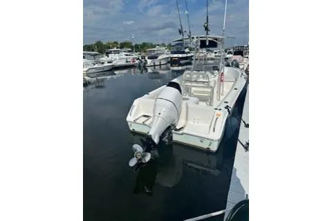 Slide: The Image of 2006 Sea Hunt Triton 220 boat docked at marina, featuring outboard motor and fishing rods. - 17