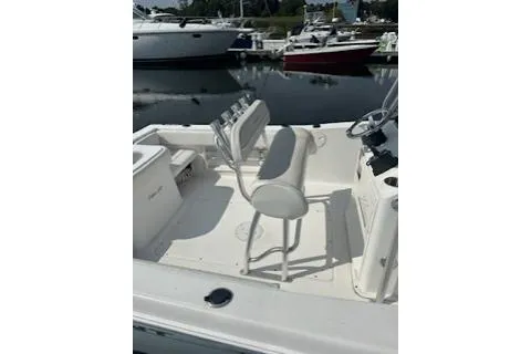 Slide: The Image of 2006 Sea Hunt Triton 220 boat interior with seating, docked at marina. - 18