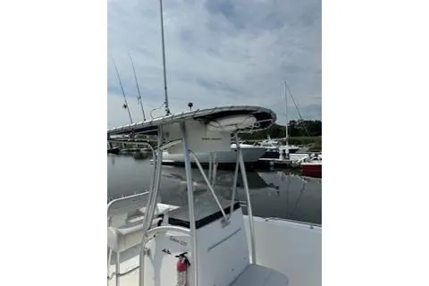 Slide: The Image of 2006 Sea Hunt Triton 220 boat docked at marina under cloudy sky. - 19