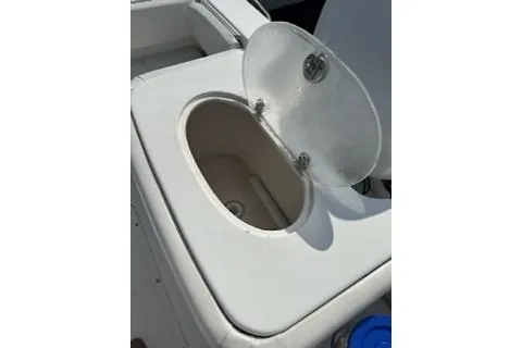 Slide: The Image of Open storage compartment on 2006 Sea Hunt Triton 220 boat. - 27