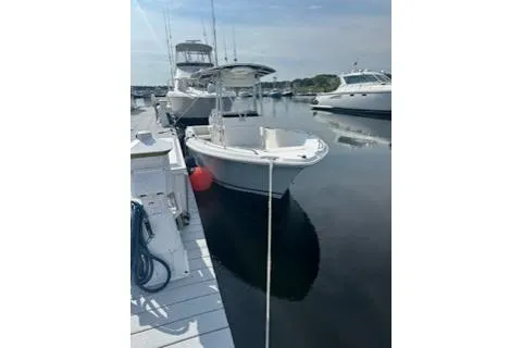 Slide: The Image of 2006 Sea Hunt Triton 220 boat docked at marina with other vessels. - 5