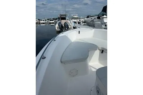 Slide: The Image of 2006 Sea Hunt Triton 220 boat docked at marina, featuring spacious seating area. - 7