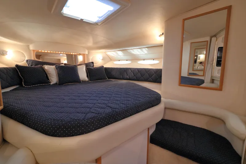 Slide: The Image of Luxurious cabin interior of 2000 Sea Ray 340 Sundancer with plush bedding and elegant lighting. - 17