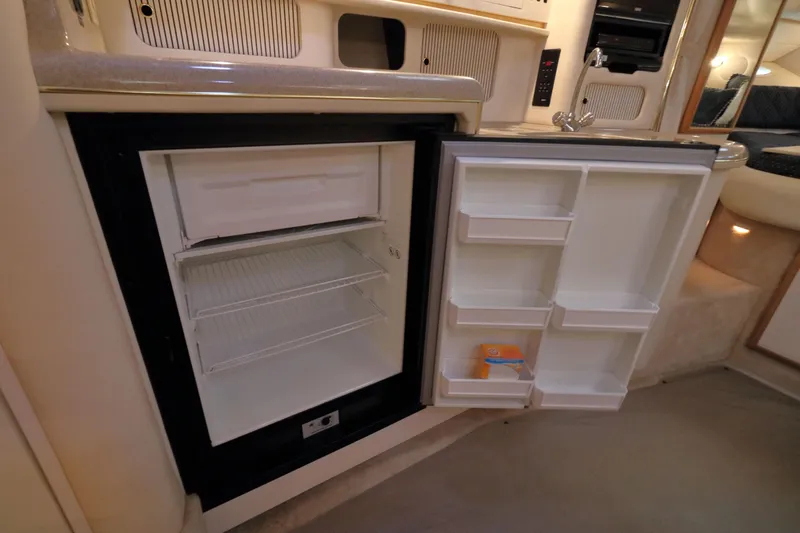 Slide: The Image of Open refrigerator in 2000 Sea Ray 340 Sundancer yacht kitchen, showcasing interior storage space. - 21