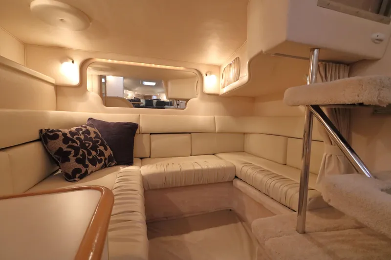 Slide: The Image of Interior of 2000 Sea Ray 340 Sundancer yacht with plush seating and elegant decor. - 24