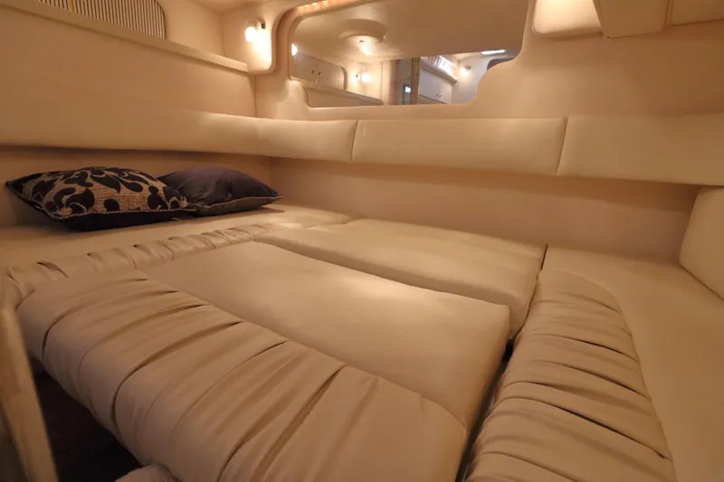 Slide: The Image of Luxurious interior cabin of 2000 Sea Ray 340 Sundancer with plush bedding and ambient lighting. - 27