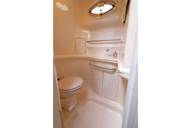 Slide: The Image of Compact bathroom in 2000 Sea Ray 340 Sundancer yacht with toilet and sink. - 28