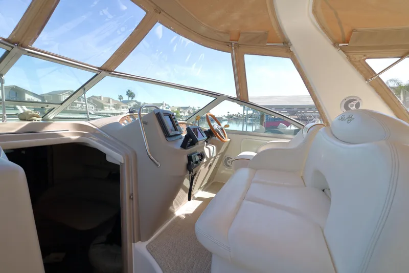 Slide: The Image of Interior of 2000 Sea Ray 340 Sundancer yacht with helm and plush seating. - 4