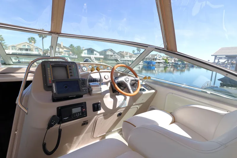 Slide: The Image of Cockpit view of 2000 Sea Ray 340 Sundancer yacht with navigation equipment and waterfront scenery. - 5
