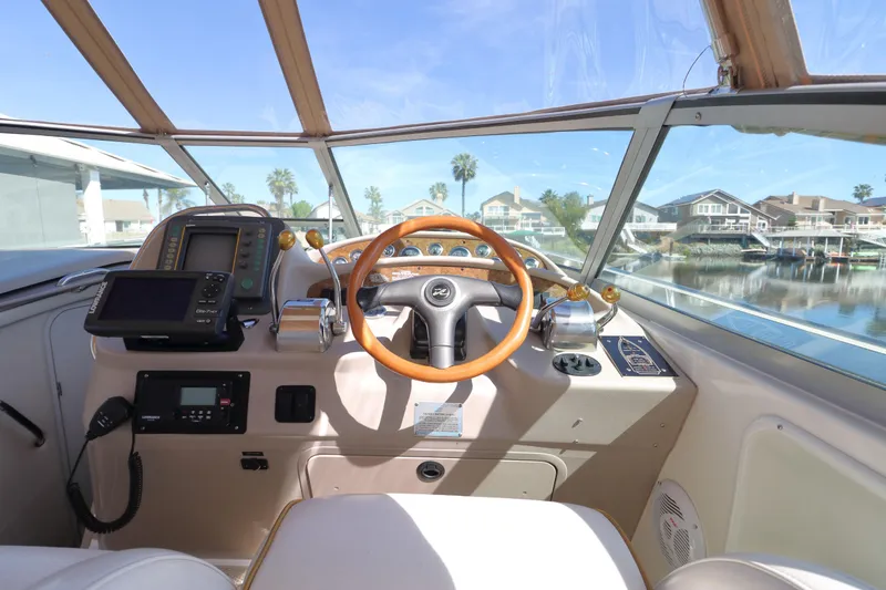 Slide: The Image of Helm of 2000 Sea Ray 340 Sundancer with wooden steering wheel and navigation equipment. - 6