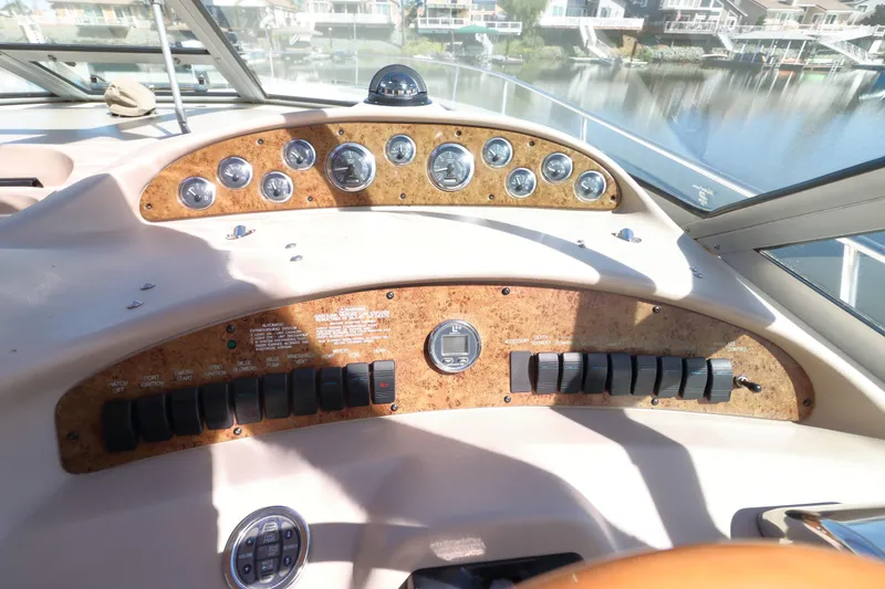 Slide: The Image of Control panel of a 2000 Sea Ray 340 Sundancer boat, featuring gauges and switches. - 7