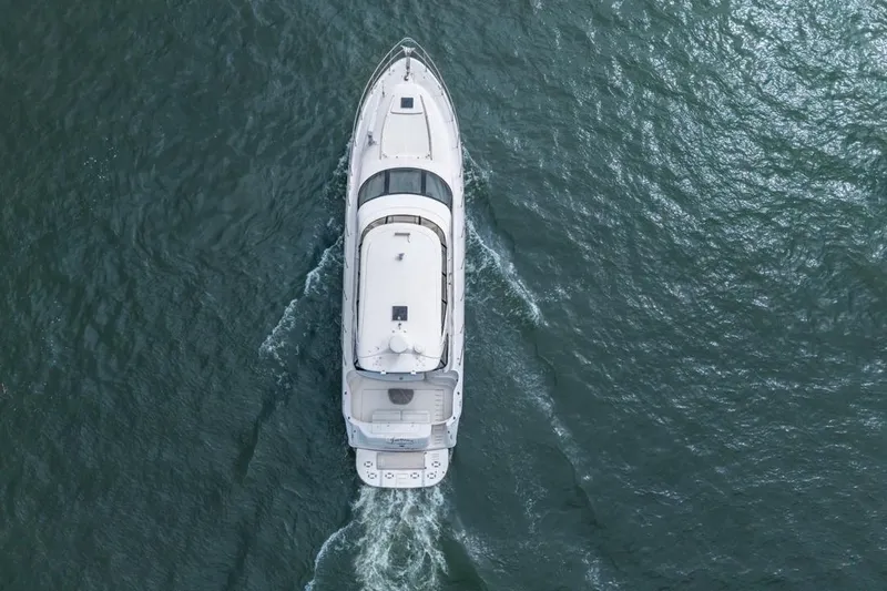 Slide: The Image of Overhead view of a 1999 Sea Ray 560 Sedan Bridge yacht cruising on open water. - 12