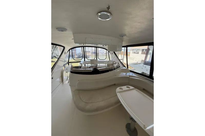 Slide: The Image of Interior view of 1999 Sea Ray 560 Sedan Bridge yacht with seating and helm. - 19