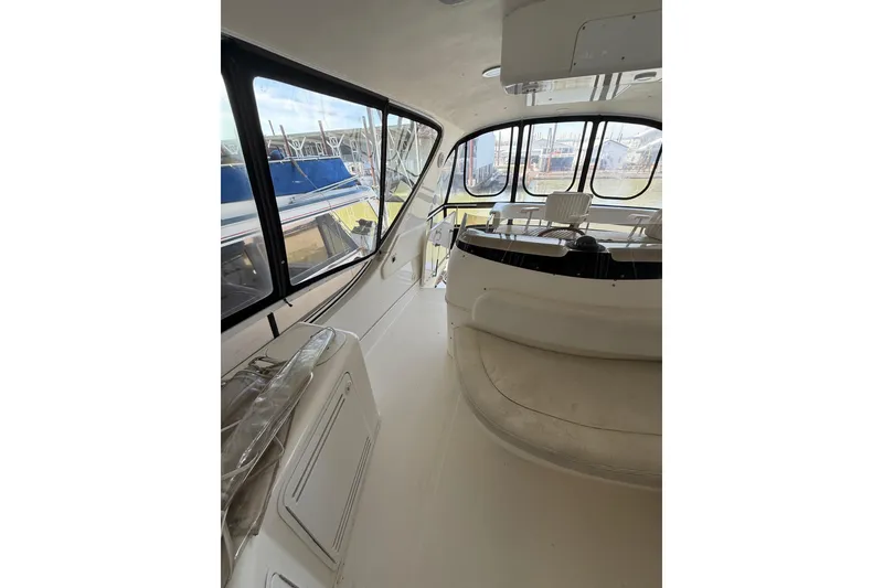 Slide: The Image of Interior view of 1999 Sea Ray 560 Sedan Bridge yacht, featuring spacious seating and large windows. - 21