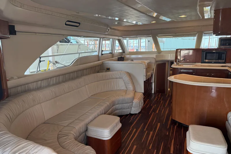Slide: The Image of Luxurious interior of a 1999 Sea Ray 560 Sedan Bridge yacht with elegant seating and wood finishes. - 24