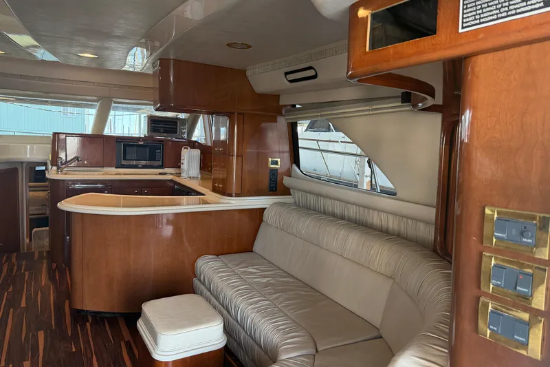 Slide: The Image of Luxurious interior of a 1999 Sea Ray 560 Sedan Bridge yacht with elegant wood finishes. - 25