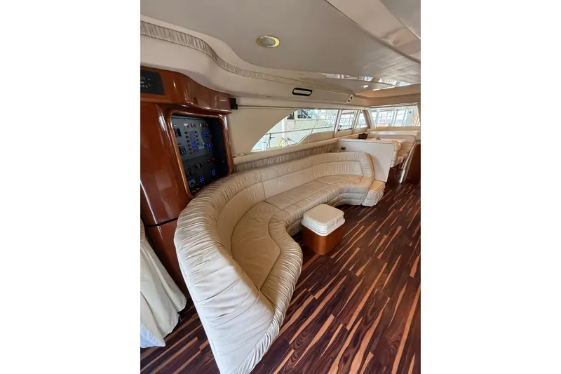 Slide: The Image of Luxurious interior of 1999 Sea Ray 560 Sedan Bridge with plush seating and elegant wood flooring. - 26