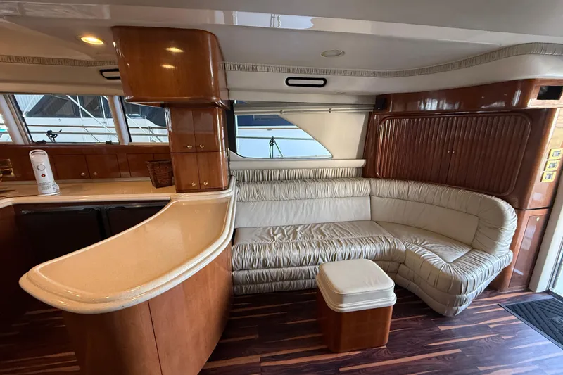 Slide: The Image of Luxurious interior of a 1999 Sea Ray 560 Sedan Bridge yacht with elegant seating and wood finishes. - 27