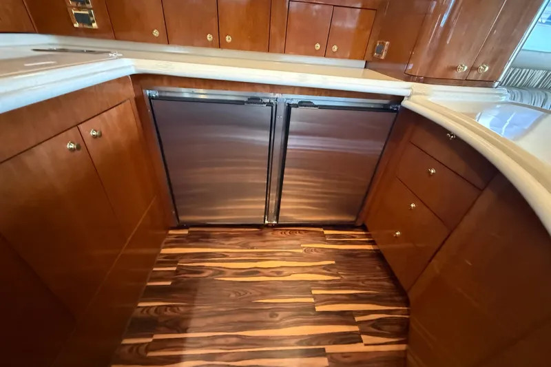 Slide: The Image of Luxurious 1999 Sea Ray 560 Sedan Bridge yacht kitchen with wood cabinetry and stainless appliances. - 31