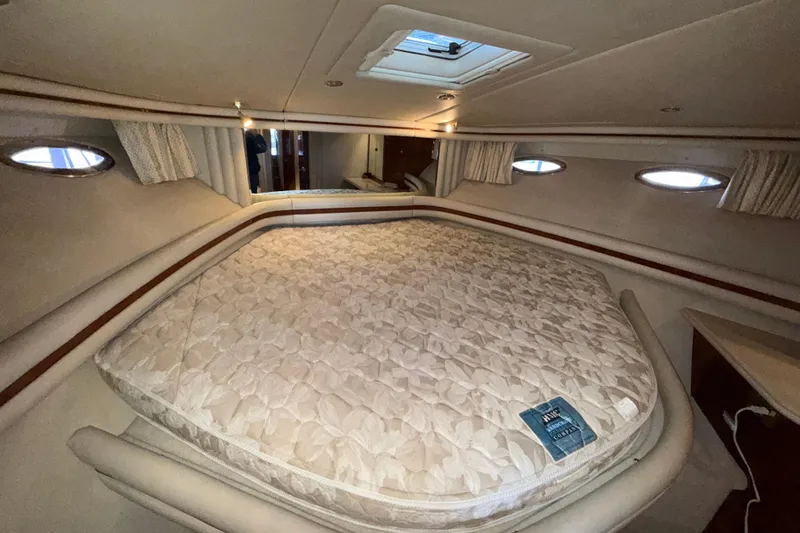 Slide: The Image of Luxurious cabin interior of 1999 Sea Ray 560 Sedan Bridge yacht with plush bedding. - 33