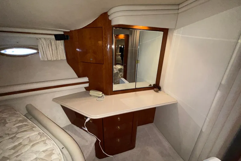 Slide: The Image of Luxurious cabin interior of 1999 Sea Ray 560 Sedan Bridge with vanity and mirror. - 34