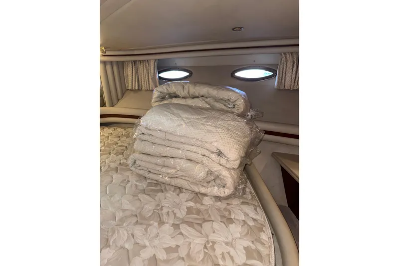 Slide: The Image of Luxurious cabin interior of 1999 Sea Ray 560 Sedan Bridge yacht with bedding. - 35
