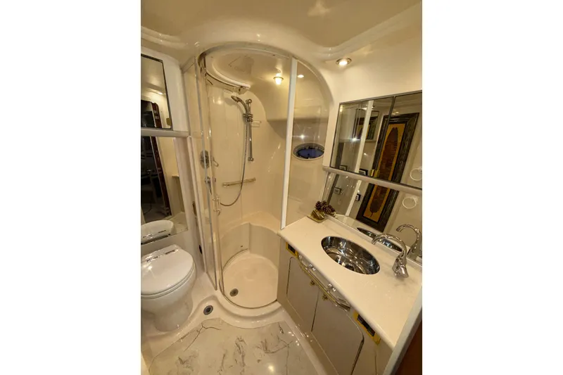 Slide: The Image of Luxurious bathroom in a 1999 Sea Ray 560 Sedan Bridge yacht, featuring a shower and vanity. - 37