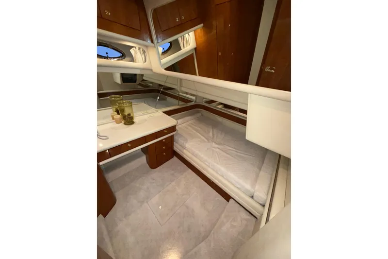 Slide: The Image of Luxurious interior of 1999 Sea Ray 560 Sedan Bridge yacht cabin with elegant wood finishes. - 38