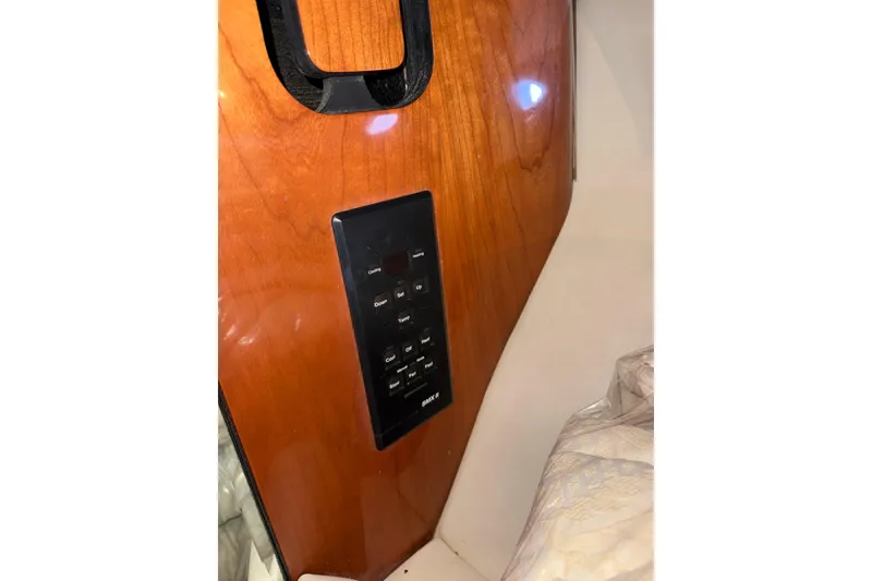 Slide: The Image of Control panel on 1999 Sea Ray 560 Sedan Bridge yacht's wooden interior. - 40