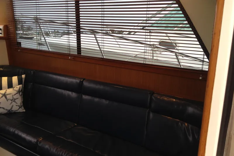 Slide: The Image of Interior of 1999 Cabo 35 Flybridge yacht with leather seating and window blinds. - 7