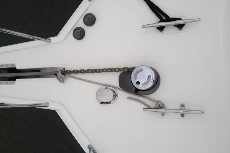 Slide: The Image of Bow of 1999 Cabo 35 Flybridge with anchor chain and cleats. - 8