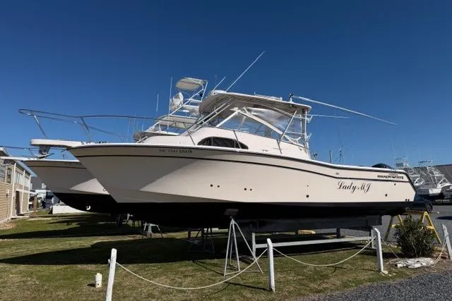 The Image of 2007 Grady-White Marlin 300 boat on display, side view, clear blue sky background. - 0