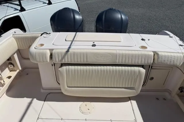 Slide: The Image of 2007 Grady-White Marlin 300 boat interior with dual engines and cushioned seating. - 10