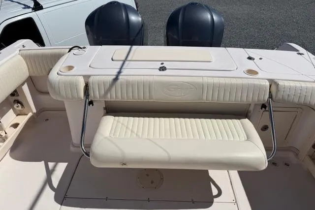 Slide: The Image of 2007 Grady-White Marlin 300 boat interior with cushioned seating and dual outboard motors. - 11