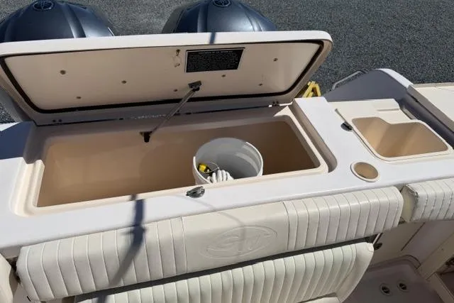 Slide: The Image of 2007 Grady-White Marlin 300 boat storage compartment with open lid and bucket inside. - 12