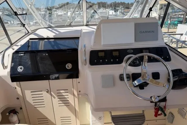 Slide: The Image of 2007 Grady-White Marlin 300 helm with Garmin navigation system and steering wheel. - 14