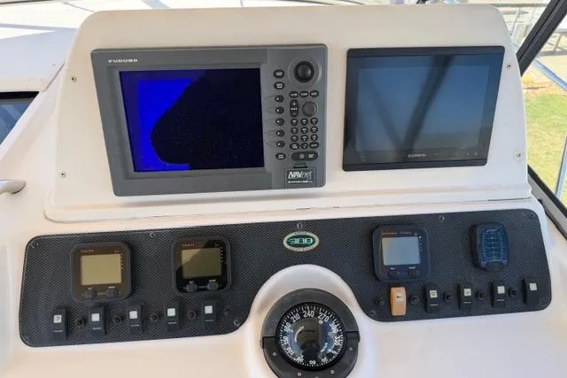 Slide: The Image of Dashboard of 2007 Grady-White Marlin 300 boat with navigation and control instruments. - 16