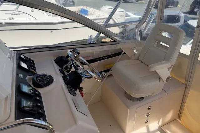 Slide: The Image of 2007 Grady-White Marlin 300 helm with steering wheel and captain's chair. - 17