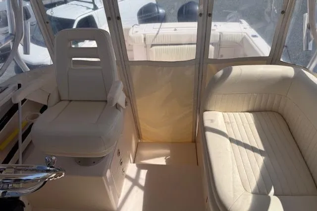 Slide: The Image of 2007 Grady-White Marlin 300 boat interior with white seating and helm. - 18