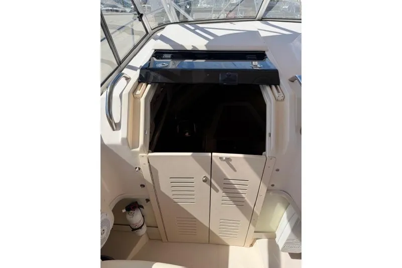 Slide: The Image of 2007 Grady-White Marlin 300 cabin entrance with closed doors and visible fire extinguisher. - 20