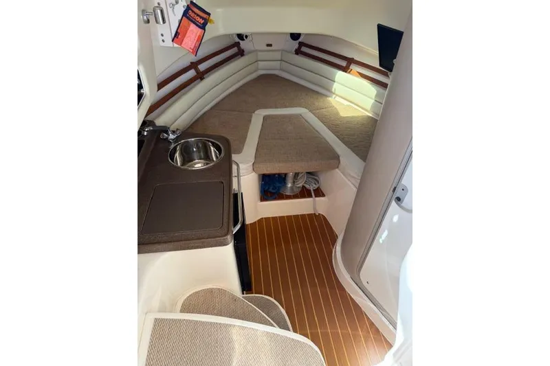 Slide: The Image of 2007 Grady-White Marlin 300 cabin interior with sink, seating, and wood flooring. - 21