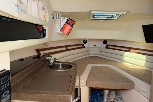 Slide: The Image of Interior of 2007 Grady-White Marlin 300 boat with kitchenette and seating area. - 22
